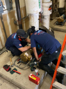 2 us comfort electricians repairing a motor